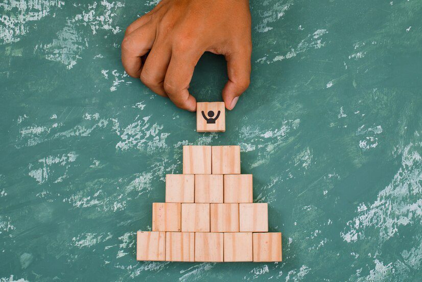 hand-putting-stacking-wooden-cubes_176474-7083